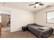 Bedroom with neutral decor, a dark-gray bed, and an adjacent room at 10922 E Wallflower Ln, Florence, AZ 85132