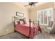 Comfortable bedroom featuring neutral walls, window, and carpet with a wrought iron bed frame at 11133 N 120Th Pl, Scottsdale, AZ 85259