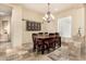 Warm dining room featuring a wood table, tile floors, and natural light, ideal for Gathering meals at 11133 N 120Th Pl, Scottsdale, AZ 85259