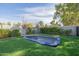 Backyard featuring an in-ground trampoline, artificial grass, and mature landscaping at 1265 E La Fortuna Ct, San Tan Valley, AZ 85140