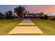 A backyard pool with a slide, artificial turf, and concrete steps, all surrounded by a secure fence at 1265 E La Fortuna Ct, San Tan Valley, AZ 85140