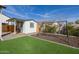 Backyard featuring a shed with a small porch, a swing set, and artificial grass at 1265 E La Fortuna Ct, San Tan Valley, AZ 85140