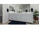 Bathroom with double sink vanity, white cabinets, and wood-look tile floors at 1265 E La Fortuna Ct, San Tan Valley, AZ 85140