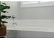 Clean white bathroom with tub and tile surround at 1265 E La Fortuna Ct, San Tan Valley, AZ 85140