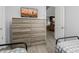 View of a bedroom with a large dresser, wood-look floors, and an open doorway at 1265 E La Fortuna Ct, San Tan Valley, AZ 85140