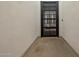 View into a courtyard through a black metal frame glass door at 1265 E La Fortuna Ct, San Tan Valley, AZ 85140