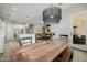 Dining room features a wood table with bench seating, pendant lighting, and view of the kitchen at 1265 E La Fortuna Ct, San Tan Valley, AZ 85140