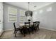 Formal dining room with a wooden table, black chairs, pendant lighting, and bright, natural light at 1265 E La Fortuna Ct, San Tan Valley, AZ 85140