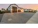 Paver driveway leads to a three-car garage with a white modern house at 1265 E La Fortuna Ct, San Tan Valley, AZ 85140