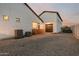 Exterior view of home with brown garage door, AC units, and gravel at 1265 E La Fortuna Ct, San Tan Valley, AZ 85140