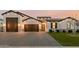 Beautiful single-story home featuring a three-car garage, manicured lawn, and modern architectural details at 1265 E La Fortuna Ct, San Tan Valley, AZ 85140