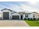 Stunning single-story home with a brick driveway, well-manicured lawn and white color scheme at 1265 E La Fortuna Ct, San Tan Valley, AZ 85140