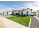 Beautiful single-story home with a 3-car garage, brick driveway, and a well-manicured front lawn at 1265 E La Fortuna Ct, San Tan Valley, AZ 85140