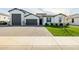 Beautiful single-story home with a brick driveway, well-manicured lawn and white color scheme at 1265 E La Fortuna Ct, San Tan Valley, AZ 85140