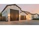 Exterior elevation of the home featuring a three-car garage and modern design at 1265 E La Fortuna Ct, San Tan Valley, AZ 85140