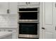 Kitchen with stainless steel double oven and white cabinets at 1265 E La Fortuna Ct, San Tan Valley, AZ 85140