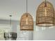 Close-up showcasing the stylish, woven pendant lights hanging above the kitchen island with natural light at 1265 E La Fortuna Ct, San Tan Valley, AZ 85140