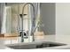 Modern kitchen sink with a stainless steel faucet and white countertops at 1265 E La Fortuna Ct, San Tan Valley, AZ 85140