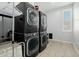 Modern laundry room with a stacked washer and dryer set and a window at 1265 E La Fortuna Ct, San Tan Valley, AZ 85140