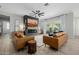 Open living area with leather sofas, a modern fireplace, large TV, and seamless indoor-outdoor flow at 1265 E La Fortuna Ct, San Tan Valley, AZ 85140