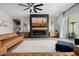Stylish living room with a fireplace, modern furniture, and a desert-themed art piece at 1265 E La Fortuna Ct, San Tan Valley, AZ 85140