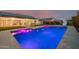 Backyard with a sparkling blue pool featuring a slide and solar panels on the roof at 1265 E La Fortuna Ct, San Tan Valley, AZ 85140