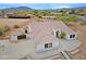 Aerial view of a home with a Spanish tile roof, desert landscaping, and a horse enclosure at 130 E Jordon Ln, Phoenix, AZ 85086