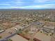 Expansive aerial view showcases a desert neighborhood dotted with homes and recreational spaces under a vast sky at 130 E Jordon Ln, Phoenix, AZ 85086