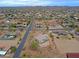 Wide aerial view showcases a desert neighborhood dotted with homes and recreational spaces under a vast sky at 130 E Jordon Ln, Phoenix, AZ 85086