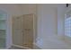Bathroom with corner bathtub and walk-in shower with tiled floors at 130 E Jordon Ln, Phoenix, AZ 85086