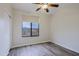 Bedroom featuring plank floors, a ceiling fan, and a window providing outdoor views at 130 E Jordon Ln, Phoenix, AZ 85086