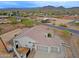 A serene, earth-toned home with a tile roof boasts a multi-car garage and fenced-in yard with desert landscaping at 130 E Jordon Ln, Phoenix, AZ 85086