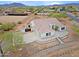 A tan stucco home with a tile roof sits in a desert landscape, with a multi-car garage and quaint walkway at 130 E Jordon Ln, Phoenix, AZ 85086