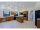 Well-lit kitchen with wooden cabinets, island, and tile flooring at 130 E Jordon Ln, Phoenix, AZ 85086