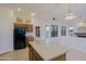 Functional kitchen featuring a central island, ample storage, and modern appliances at 130 E Jordon Ln, Phoenix, AZ 85086