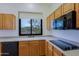 Modern kitchen with wood cabinets, sleek appliances, and a window overlooking the desert at 130 E Jordon Ln, Phoenix, AZ 85086