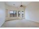 Large bedroom with neutral carpet, a ceiling fan, and private outdoor access at 130 E Jordon Ln, Phoenix, AZ 85086