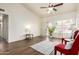 Bright living room with high ceilings, wood floors, and natural light from large windows at 1417 N Brittany Ln, Gilbert, AZ 85233