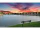 Scenic view of lake at sunset, with bench seating, showcasing tranquil community waterfront at 16013 S Desert Foothills Pkwy # 2089, Phoenix, AZ 85048