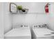 Functional laundry room with washer, dryer, and storage shelves at 16013 S Desert Foothills Pkwy # 2089, Phoenix, AZ 85048