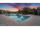 Community pool and relaxation area, featuring tropical landscaping and seating, under a vivid sky at 16013 S Desert Foothills Pkwy # 2089, Phoenix, AZ 85048