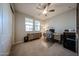 Bedroom area includes a ceiling fan, natural light, and a neutral, cozy interior design at 16071 W Sand Hills Rd, Surprise, AZ 85387