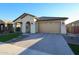 Beautiful single-story home featuring a neutral color scheme, paver driveway and a two-car garage at 16071 W Sand Hills Rd, Surprise, AZ 85387