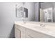 Bathroom featuring dual sinks, white cabinets, a large mirror and lighting at 1635 W Dunbar Dr, Phoenix, AZ 85041