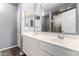 Bright bathroom features a double sink vanity with white cabinets and a shower with a neutral-patterned curtain at 1635 W Dunbar Dr, Phoenix, AZ 85041