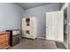 Bedroom featuring a gray walls, carpet, a mini fridge, and a white door at 1635 W Dunbar Dr, Phoenix, AZ 85041