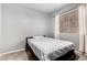 Bedroom featuring a bed, carpet flooring, and a large window with neutral-toned walls at 1635 W Dunbar Dr, Phoenix, AZ 85041