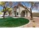 Two-story home with a two-car garage, neutral paint scheme, lawn, and mature trees at 1635 W Dunbar Dr, Phoenix, AZ 85041