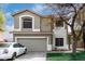 Two-story home with a two-car garage, neutral paint scheme, lawn, and mature trees at 1635 W Dunbar Dr, Phoenix, AZ 85041