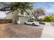 Two-story home with a two-car garage, neutral paint scheme, lawn, and mature trees at 1635 W Dunbar Dr, Phoenix, AZ 85041